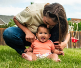Mother and baby on lawn